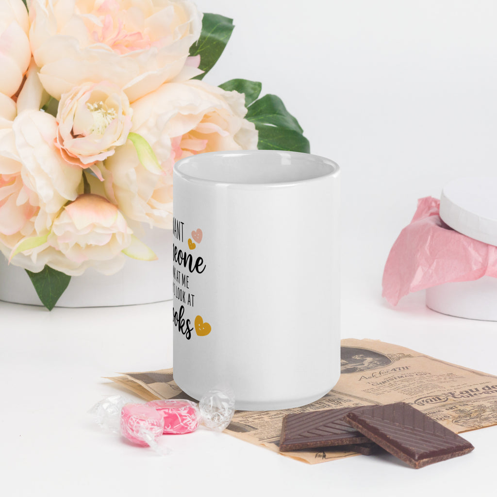 White mug showing partial “I want… books” text with heart icons