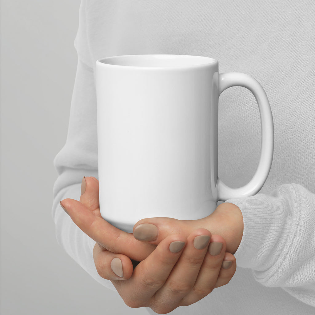 Plain white ceramic mug held in two hands